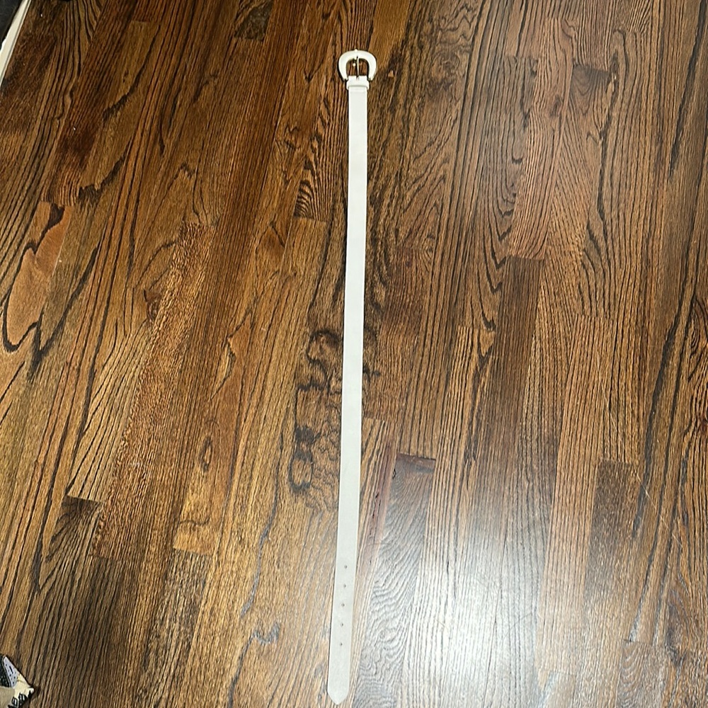 B-low the belt white belt with gold trim on buckle.  Never worn.